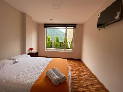 a bedroom with a large bed and a window at Hotel Shannon 360 in Baños
