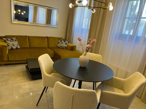 a living room with a table and chairs and a couch at Villa Central in Crikvenica
