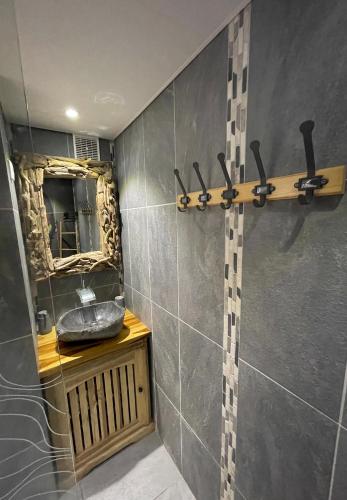 a bathroom with a sink and a mirror at Diamond Studio KANAN in Le Diamant