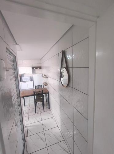 a bathroom with a mirror and a table in it at Casa aconchegante no centro da cidade in Itatiba