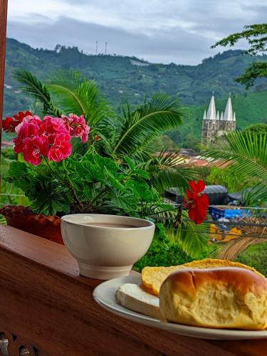 a plate of bread and a bowl on a table at Hotel Macao in Jardin