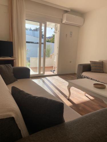 a living room with a couch and a table at Atalay Apart Otel in Bodrum City