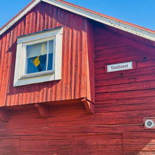 a red building with a window and a sign on it at Visthuset, historical cottage at Långnäs Manor in Långnäs