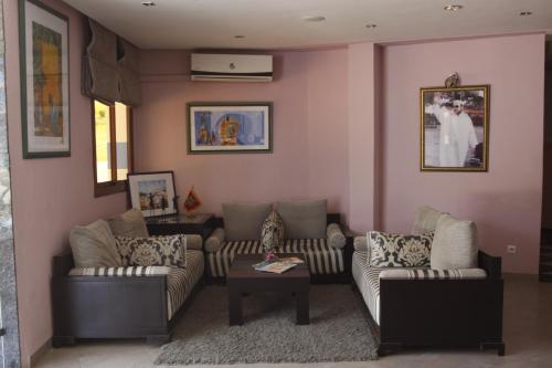 a living room with two couches and a table at Hotel Chaouen in Chefchaouene