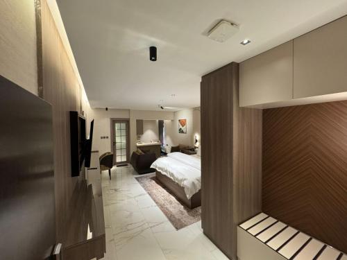 a bedroom with a bed and a living room at SIXTY THREE HOTEL SUiTES in Riyadh