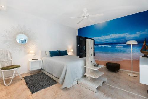a bedroom with a bed and a blue wall at pardelo in Adeje