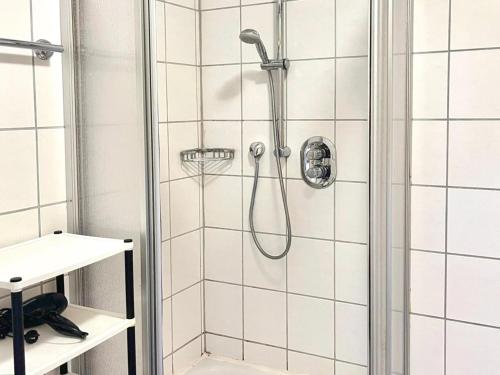a shower with a shower head in a bathroom at Am Damwildgehege II in Oberveischede