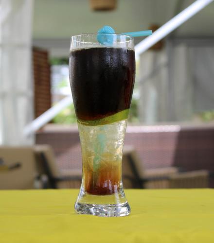 a drink in a glass sitting on a table at Almadies Prestige in Parakou