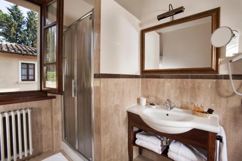 a bathroom with a sink and a mirror at Villa Poggiano in Montepulciano