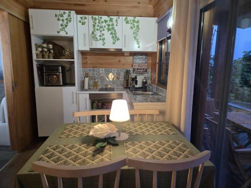 a small kitchen with a table with a lamp on it at Rosegarden View in Velas