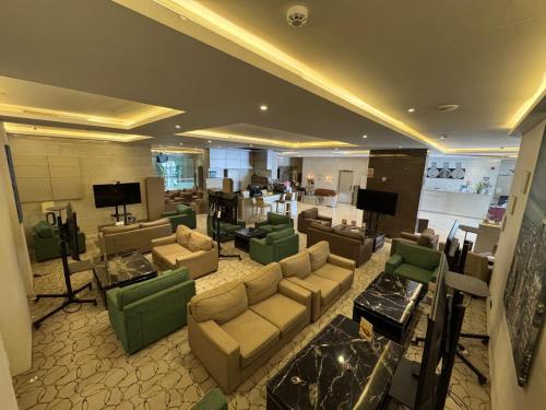 a large living room with couches and tables at SIXTY THREE HOTEL SUiTES in Riyadh
