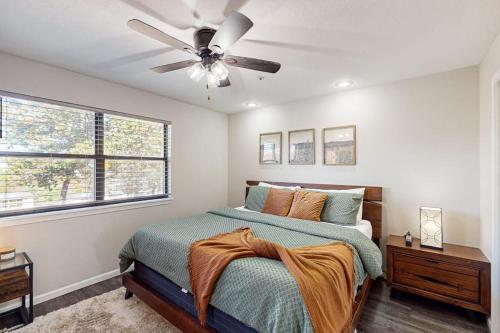 a bedroom with a bed with a ceiling fan at Silver Linings at Pointe Royale in Branson