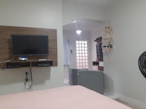 a white room with a bed and a flat screen tv at FLAT -Apartamento na Pedreira Belém in Belém