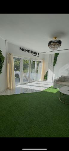 a living room with green grass and a room with a couch at Panorama Villa House Sarajevo- Jacuzzi, Bazen & Pogled na Grad 1 in Sarajevo