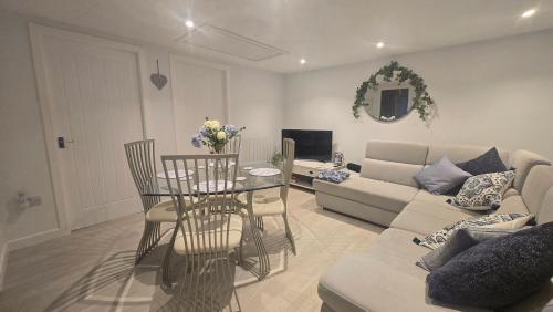 a living room with a couch and a table at Charlies Cottage in Inverness