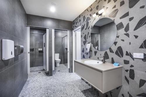 a bathroom with a sink and a mirror at Royal Hotel by Nightcap Social in Melbourne