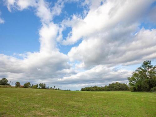 a large open field with a cloudy sky at Luxury Villa in France with Private Pool in Les Forges