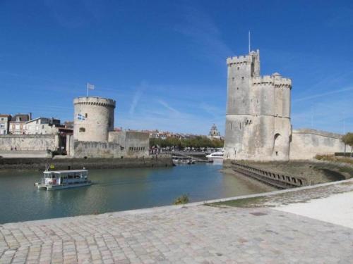 a castle on a river with a boat in it at Luxury Villa in France with Private Pool in Les Forges