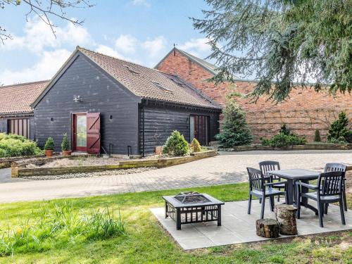 a black house with two chairs and a table at Cedar Barn - Ukc5406 in Banham