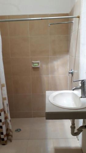 a bathroom with a sink and a shower at Chelem Puerto Furnished House in Chelem