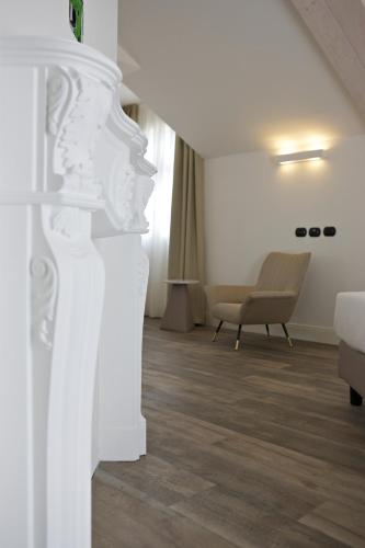 a living room with a couch and a chair at Hotel Al Campanile - Luxury Suites & Apartments in Baveno