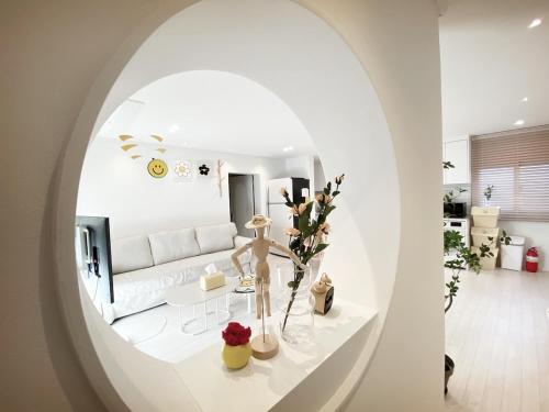 a living room with a white couch and a white table at Luxury for family, terrace, 3room,2bath,metro 1min in Seoul