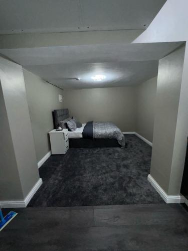 an empty room with a bed in the middle of it at Private Studio Retreat with WiFi & HD TV & Workspace in Huddersfield
