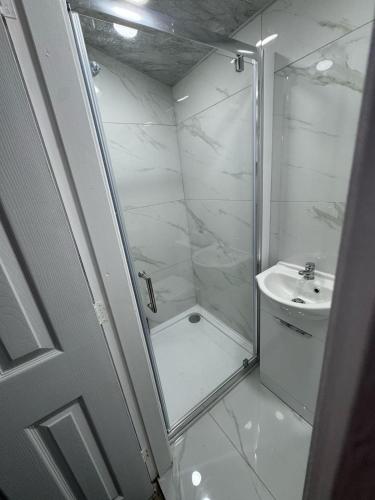 a bathroom with a shower and a sink at Private Studio Retreat with WiFi & HD TV & Workspace in Huddersfield