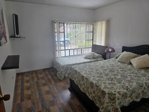a bedroom with a bed and a window at Finca Villa Claudia, La Mesa, Cundinamarca in La Mesa