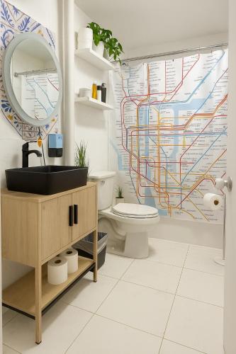 a bathroom with a toilet and a sink and a mirror at Tropical style room in Geusthouse in New York