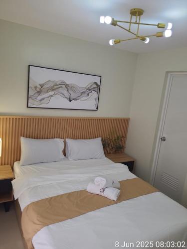 a bedroom with a bed with a towel on it at Serenity 3 New cozy Home in Balintiouac