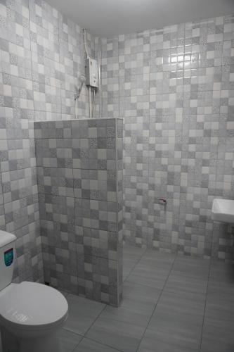 a bathroom with a toilet and a sink at Khao Sok Palmview Resort in Khao Sok