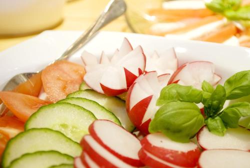 a white bowl filled with vegetables on a table at Hotel Sonne in Seiffen