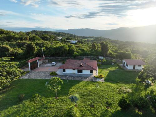 an aerial view of a house on a green field at Finca Villa Claudia, La Mesa, Cundinamarca in La Mesa