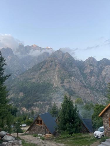 a view of a mountain range with a house at Shepherd's Lore Camps & Resort in Sāngla