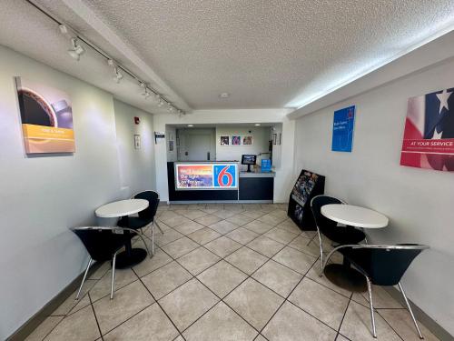 a waiting room with two tables and a tv at Motel 6-West Monroe, LA in West Monroe