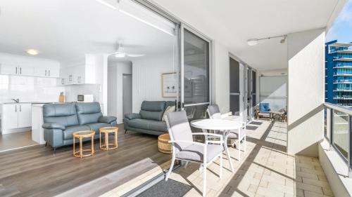 a living room with a couch and a table at Beachpoint 402 in Forster