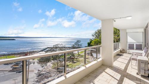 a balcony with a view of the ocean at Beachpoint 402 in Forster