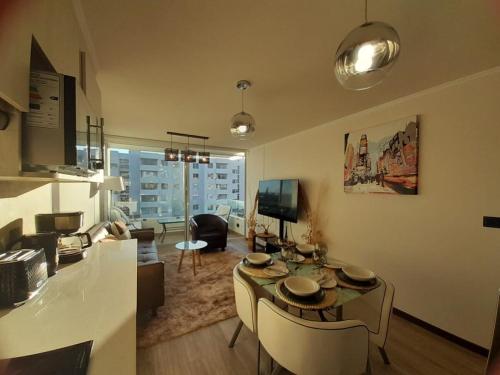 拉塞雷纳Brisa Serena Suites Dpto 2D 2B Full Equipado的房间里有一张桌子和几把椅子的客厅