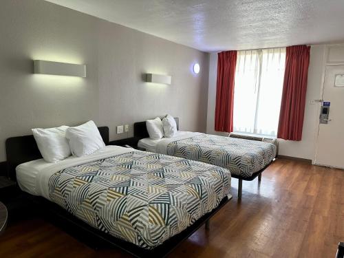 a hotel room with two beds and a window at Motel 6-West Monroe, LA in West Monroe
