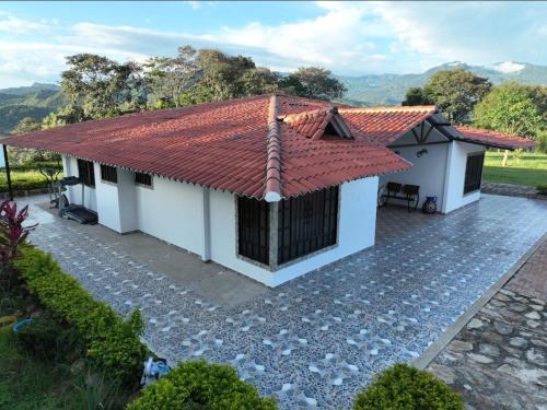an image of a house with a red roof at Finca Villa Claudia, La Mesa, Cundinamarca in La Mesa