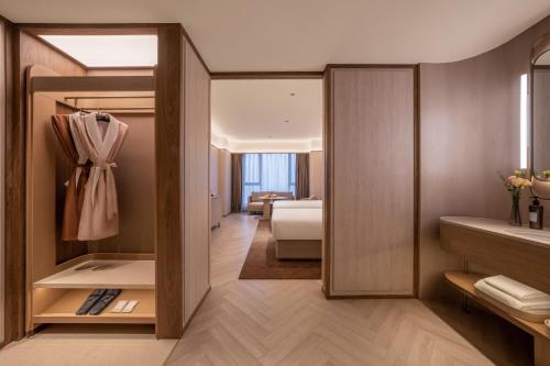 a room with a bedroom with a bed and a room with at Orange Crystal Beijing Capital Airport New International Exhibition Hotel in Beijing