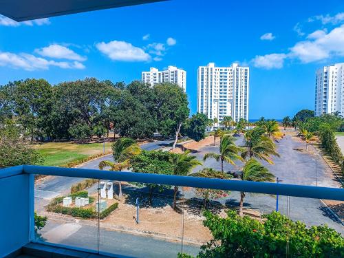 a balcony with a view of a park and buildings at Golden Sun Penthouse VIP in Playa Blanca