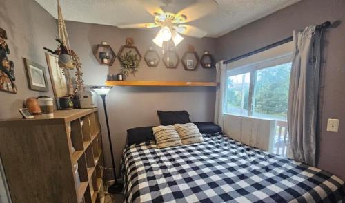 a bedroom with a black and white checkered bed at Last Frontier Lodge - Forest, Mountain, Ocean Views in Kodiak
