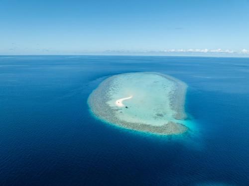 a small island in the middle of the ocean at Kirulhiya Maldives - Omadhoo in Omadhoo