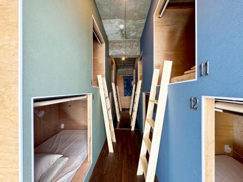 two bunk beds in a room with blue walls at 石垣ゲストハウスオハナ in Ishigaki Island