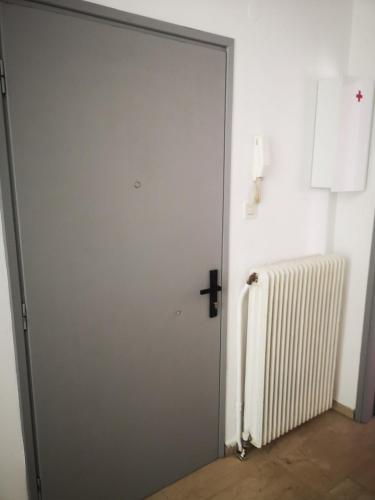 a door with a cross on it next to a radiator at Spacious Family-Friendly 2BR Flat Near City Center in Alexandroupoli