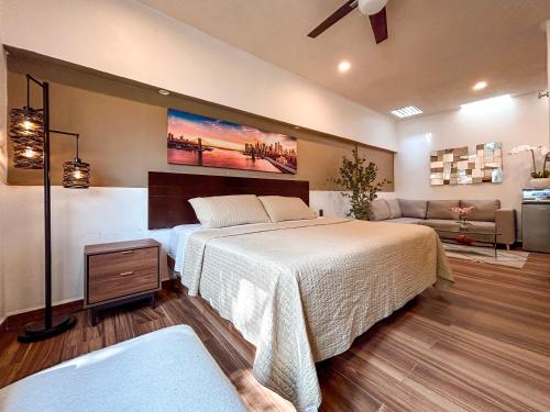 a bedroom with a large bed and a couch at Hotel Boutique Luciérnaga in Chiconcuac