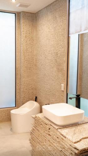 a bathroom with a white tub and a sink at Taradol Premium by Tukta in Hua Hin