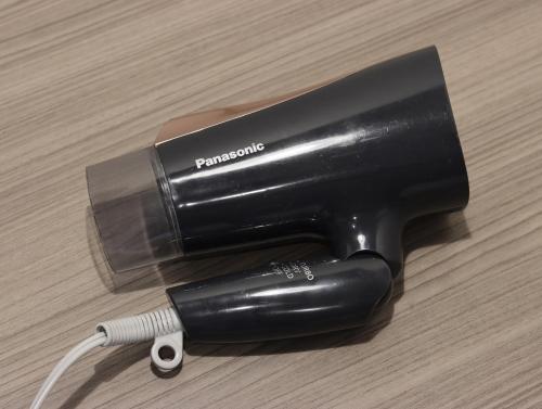 a black blow dryer sitting on a table with a wire at Wander Kyoto Nanajo in Kyoto